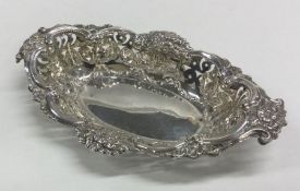 A chased silver bonbon dish with floral decoration