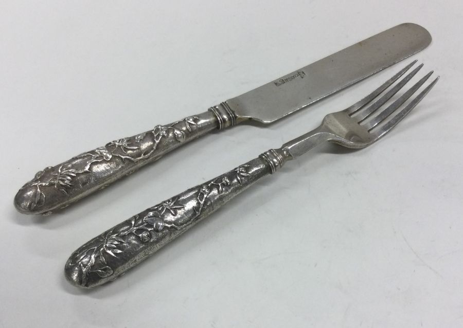 A good Chinese silver knife and fork set with tape