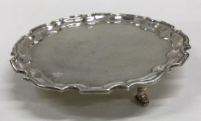 A circular silver waiter with shaped border. Londo