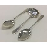 A pair of silver mounted preserve spoons together