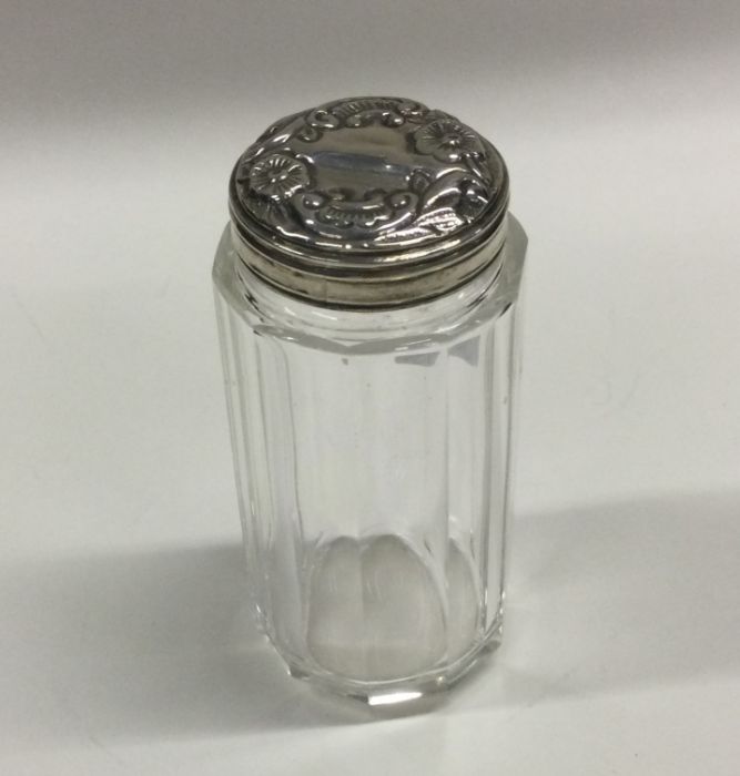 A chased silver mounted scent bottle embossed with