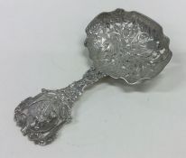 A heavy silver preserve spoon decorated with birds