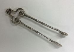 A pair of stylish silver sugar tongs with spring m