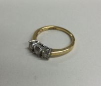 A diamond three stone ring in two colour 18 carat