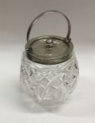 A heavy Edwardian silver and glass biscuit barrel