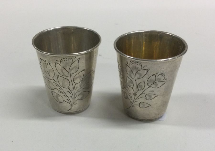 A pair of Russian silver tapering beakers engraved