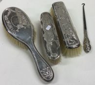 A silver mounted hairbrush together with two other