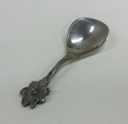 A Continental silver caddy spoon decorated with fl