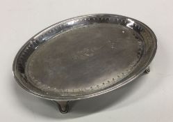 A good oval George III silver teapot stand on tape