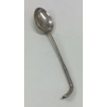 A stylish silver spoon in the form of a golfing wo