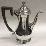 A heavy Georgian silver baluster shaped coffee pot