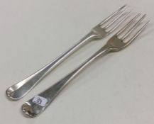 A pair of early Georgian silver three prong forks.