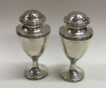 A good pair of Colonial-Indian cast silver peppere