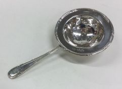 A good heavy silver tea strainer of typical form.