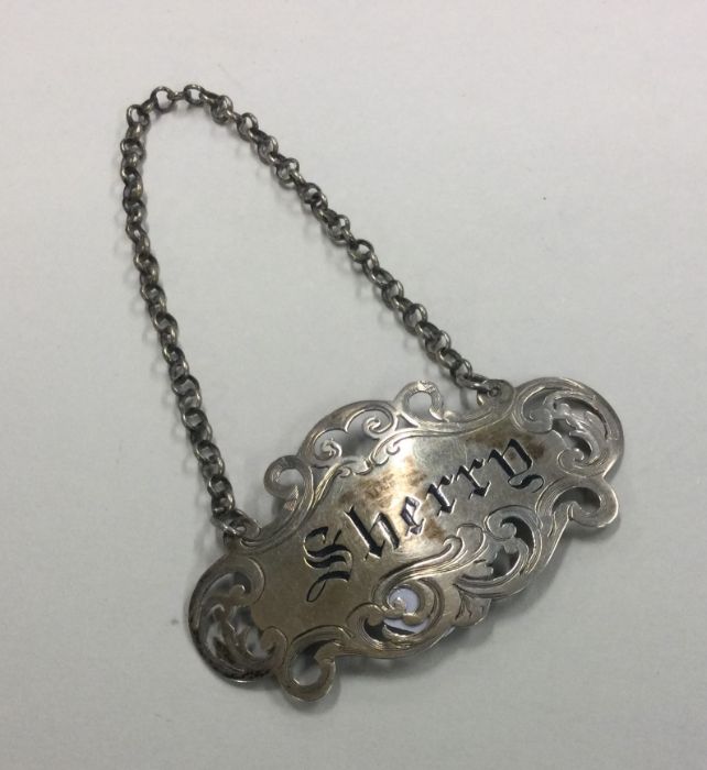 An unusual Victorian pierced silver wine label for
