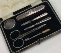 A cased silver mounted manicure set. Birmingham. B