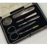 A cased silver mounted manicure set. Birmingham. B