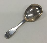 A large silver caddy spoon. London. By FH. Approx.