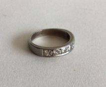 A heavy platinum and diamond half eternity ring. A