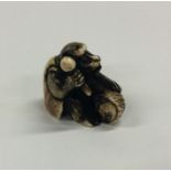 A small carved ivory netsuke in the form of a monk