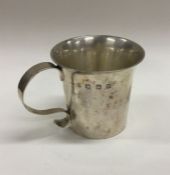 A large tapering silver christening mug of shaped