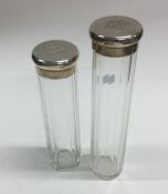 Two silver mounted dressing table jars. Est. £20 -