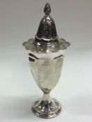 A large unusual silver sugar caster of shaped form