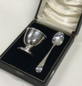 An Edwardian silver egg cup together with matching