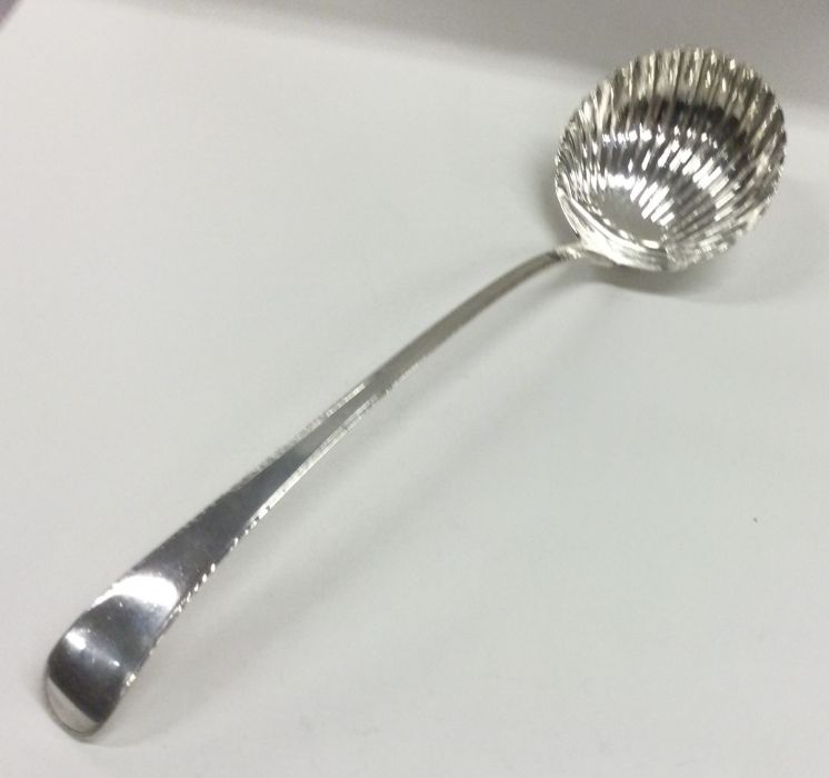 A large George III silver fluted soup ladle with f