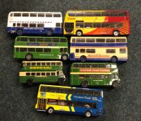 A collection of diecast toy double decker buses of