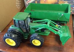 A child's preloved John Deere tractor.