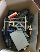 A large box containing Playmobil train sets etc.