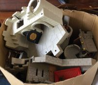 A box containing Playmobil knights, castles, drago