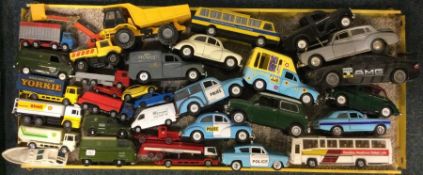 A diecast toy police car together with other toy v