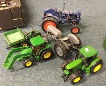 A box containing diecast toy tractors of varying m