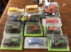 A group of cased toy tractors etc.