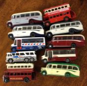 A collection of diecast toy buses and coaches of m