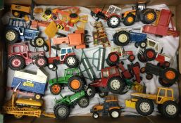 A diecast toy tractor together with other toy trac