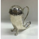 An unusual silver sugar caster of cornucopia desig