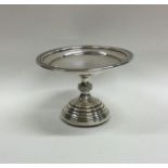 A small circular silver sweet dish on reeded base.