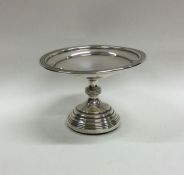 A small circular silver sweet dish on reeded base.