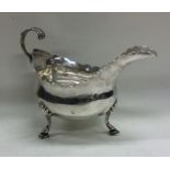 A tall slender Georgian silver sauce boat with car