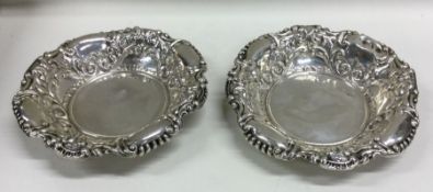 A pair of heavy circular silver bonbon dishes embo