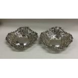 A pair of embossed silver bonbon dishes of scroll