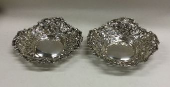 A pair of embossed silver bonbon dishes of scroll