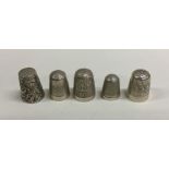 A group of five heavy silver thimbles. Various dat