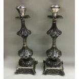 A pair of Continental filigree decorated candlesti
