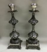 A pair of Continental filigree decorated candlesti