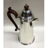 A large tapering silver hot water jug with hinged