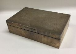 A stylish silver cigarette box with reeded decorat